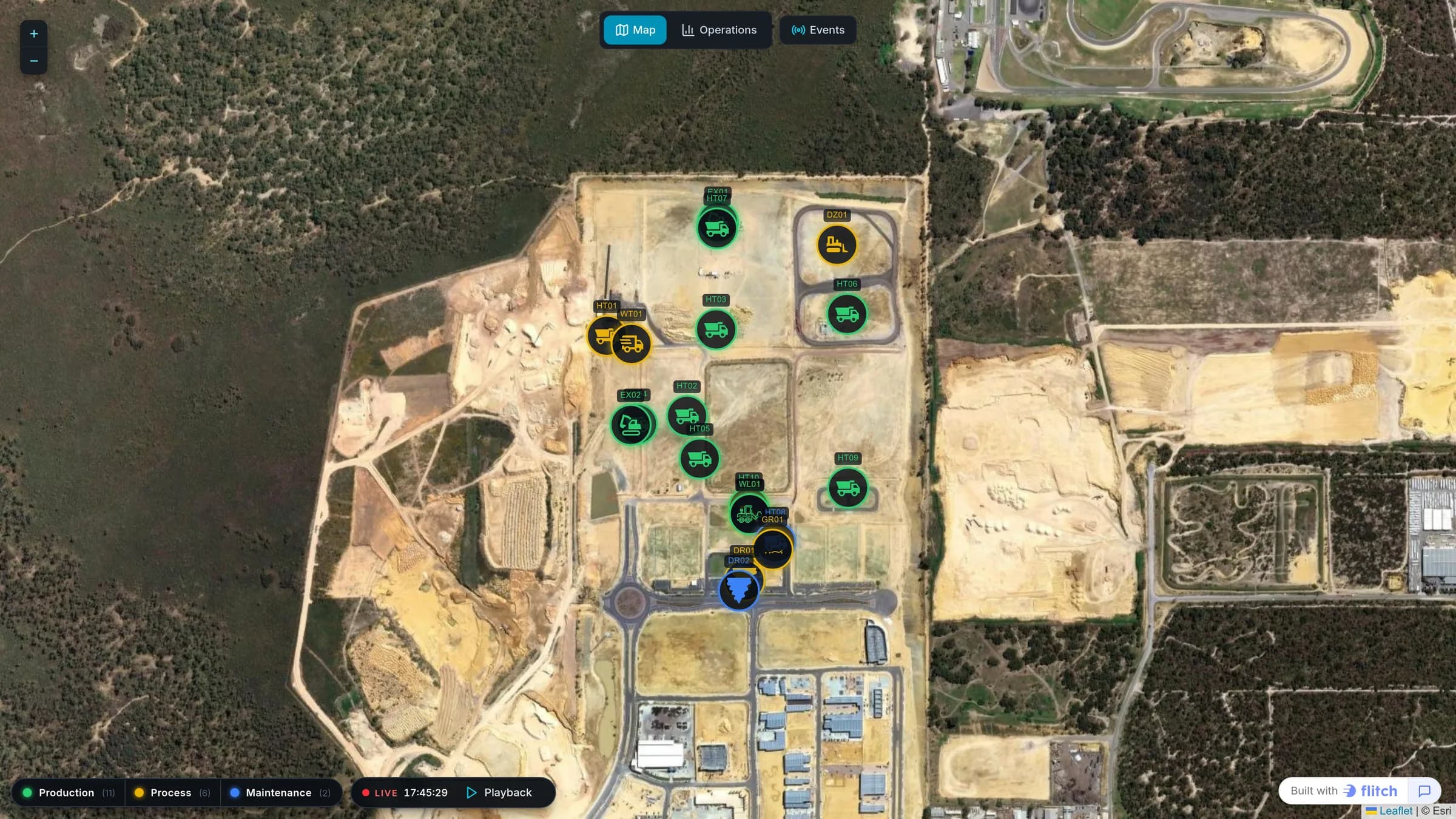 Satellite map of an open-pit mine with haul trucks, excavators and drills marked and colored by status, above a playback bar and a status legend